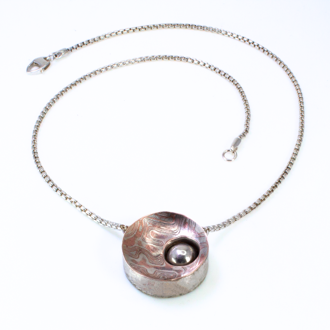 "That's No Moon!" - Reversible Hollowform Necklace in Silver, 22k gold, and Mokume Gane