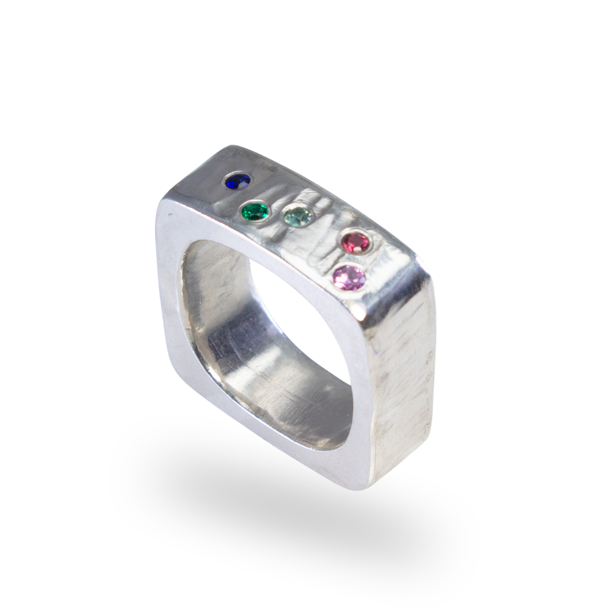 Square silver hollowform with flush set sapphires and emerald rainbow