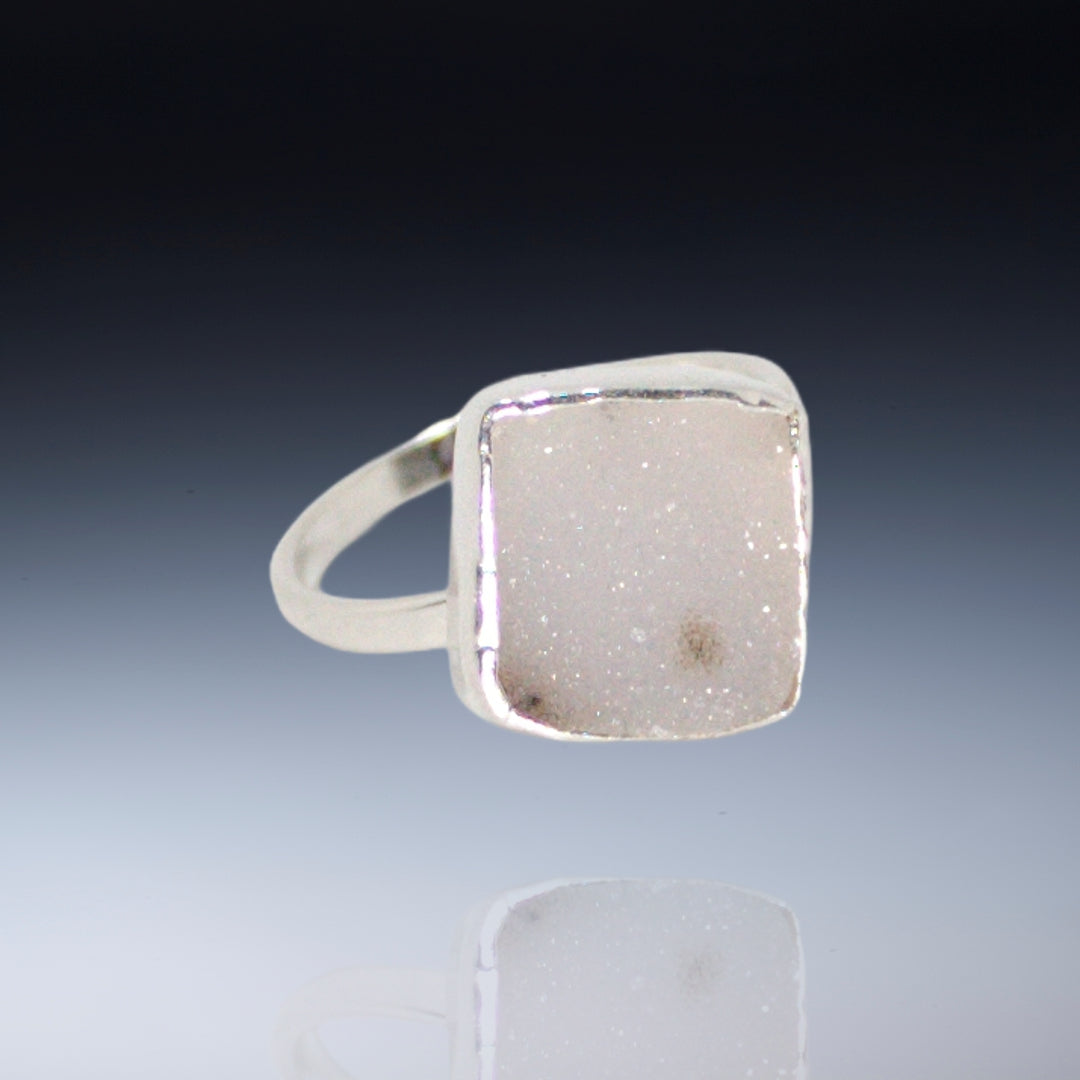 Small white square drusy with deep brown inclusions on narrow band sterling ring